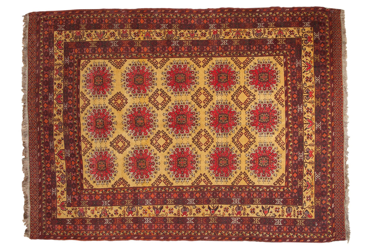 Vintage Daulatabad carpet featuring red floral guls in a grid pattern across a saffron yellow field.