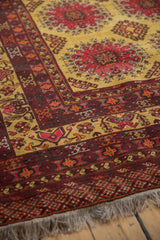 Corner view of a vintage Daulatabad carpet showing the full pile, intricate geometric border, and clean fringe.