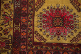 Detailed corner of a vintage Daulatabad rug showing its plush saffron pile and red floral motifs.