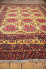 Low angle on the intricate border and short fringe of a vintage hand-knotted Daulatabad carpet.