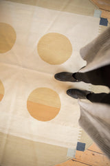 Subtle abrashes on abstract gold circles and ivory ground of the contemporary kilim.