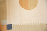Contemporary kilim detail with navy square, ivory, and sand 'toothed' edge pattern.