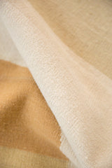 Fine weave and natural texture of the contemporary kilim in ivory and sand tones.
