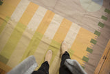 Pale gold, green, and beige abstract geometric vintage Kilim rug pattern.