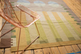 Vintage contemporary kilim rug with abstract geometric stripes, abrashes, and pale tones.