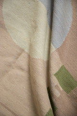 Vintage contemporary kilim texture with abstract shapes in folded beige, pale blue, and green.