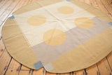 Contemporary kilim rug edge detail with pale blue, sand, and ivory rectilinear motifs.