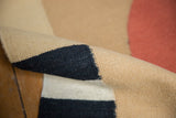 Handwoven Kilim flatweave in beige and charcoal black, with visible selvage.