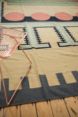 Geometric track patterns in charcoal and beige on a vintage contemporary Kilim rug corner.