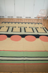 Contemporary flatweave Kilim carpet showcasing striped bands in emerald green, cinnabar red, ivory, and bronze.