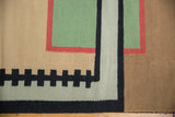 Geometric blocks and stepped pattern on Contemporary Kilim in sand, green, red, and black.