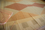 Contemporary Kilim rug displaying gold, sand, and terracotta geometric shapes and color bands.