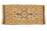 Vintage Moroccan runner rug in saffron yellow with a geometric diamond medallion and floral motifs.