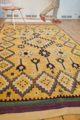 Low angle view of a vintage Moroccan rug runner's soft saffron pile and geometric medallions.