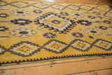 Soft wool pile of a Moroccan runner with geometric and floral motifs in saffron yellow.