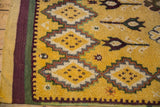 Intact purple and green side cord selvages border the thick, hand-knotted saffron yellow pile.