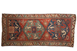 Antique Kazak rug runner with oversized double medallions and cloud-band dragon motifs in red, blue, and green.