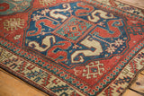 Corner detail of a late 19th-century Kazak rug's serrated leaf and pawn motif borders.