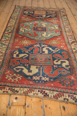 Low angle view of an antique Kazak runner showing its cloud-band dragon and medallion design.