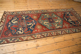 Perspective view down the full length of a late 19th-century Kazak runner and its dragon medallions.