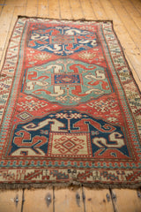 Perspective view showcasing the bold medallion design of a late 19th-century Caucasian Kazak rug runner.