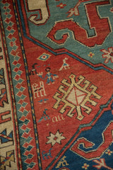 Pictorial herds-people and bird figures beside the reciprocating pawn motif border of an antique Kazak rug.