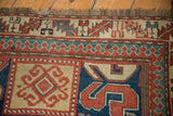 Antique Kazak runner's short end fringe above its geometric pawn and leaf motif borders.