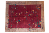 Antique hand-knotted Nichols Art Deco rug, cranberry red field, sprawling floral vines, beige border.