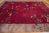 Antique Nichols Art Deco carpet: cranberry red field and beige border with sprawling floral design.