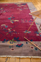 Art Deco Nichols carpet: delicate blue, gold, green blossoms on cranberry red field and beige border.