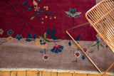 Corner of antique Nichols Art Deco carpet, beige border, crisp fringe, delicate stemmed blossoms.