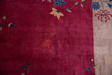 Art Deco Nichols carpet's wine cranberry red field, beige border, and delicate blue-gold floral motifs.
