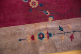 Delicate Art Deco floral motifs on the wine cranberry field and sand border.