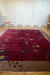 Antique Nichols Art Deco carpet with a deep cranberry field and sprawling blue-gold blossoms.