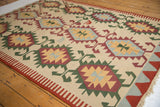 Vintage Turkish Kilim corner: red and ivory side selvage, fringe, serrated geometric motifs.
