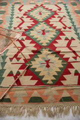 Turkish Kilim lower border with geometric peach, mallard green, ivory patterns and natural fringe.