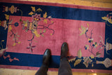 Sprawling floral, vase, and butterfly motifs on a faded raspberry pink Art Deco runner.