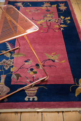 Art Deco rug with faded raspberry field, cobalt blue border, and intricate butterfly motif.
