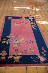 Art Deco Nichols rug corner, cobalt blue border, faded raspberry pink plant motif.