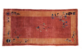 A Collector's vintage Nichols Art Deco runner rug in copper with a sand border and symbolic floral motifs.