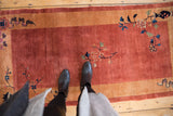 Looking down at the dense, plush pile of a vintage Nichols rug with delicate floral sprays.