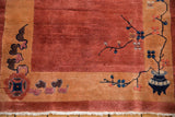 Corner detail of an Art Deco Nichols rug with a potted vase and delicate floral sprays.