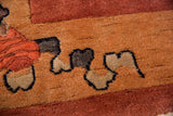 Plush, full pile of a hand-knotted Art Deco Nichols rug in copper, sand, and navy blue.