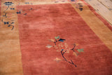 Detailed view of the dense, full pile and delicate scrolling floral motifs on a copper and sand Nichols rug.