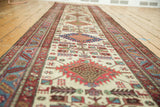 Angled view of a vintage Karaja runner highlighting its serrated border and repeating medallions.