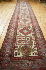 Angled view down the length of a vintage Karaja runner showcasing its repeating geometric medallions.