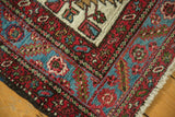Sharply serrated border in sky blue and red on the corner of a hand-knotted vintage Karaja rug.