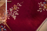 Vintage Art Deco rug with detailed floral sprays on a rich burgundy red hand-knotted pile.