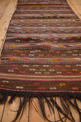 Vintage Jijim runner's coffee brown bands with pink, orange, and yellow geometric serpent motifs.