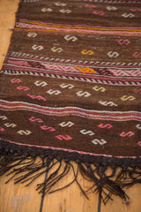 Hand woven vintage Jijim runner showcasing embossed serpent motifs, geometric bands, and dark fringe.